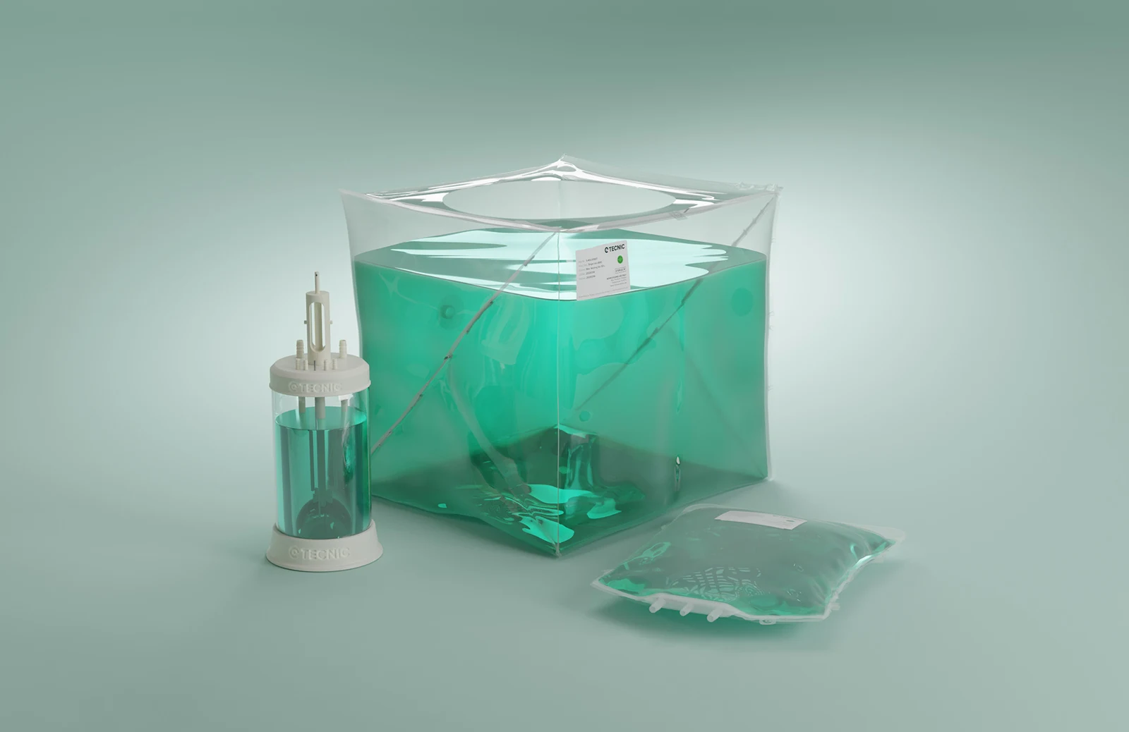 TECNIC bioprocess components with transparent vessels containing green liquid